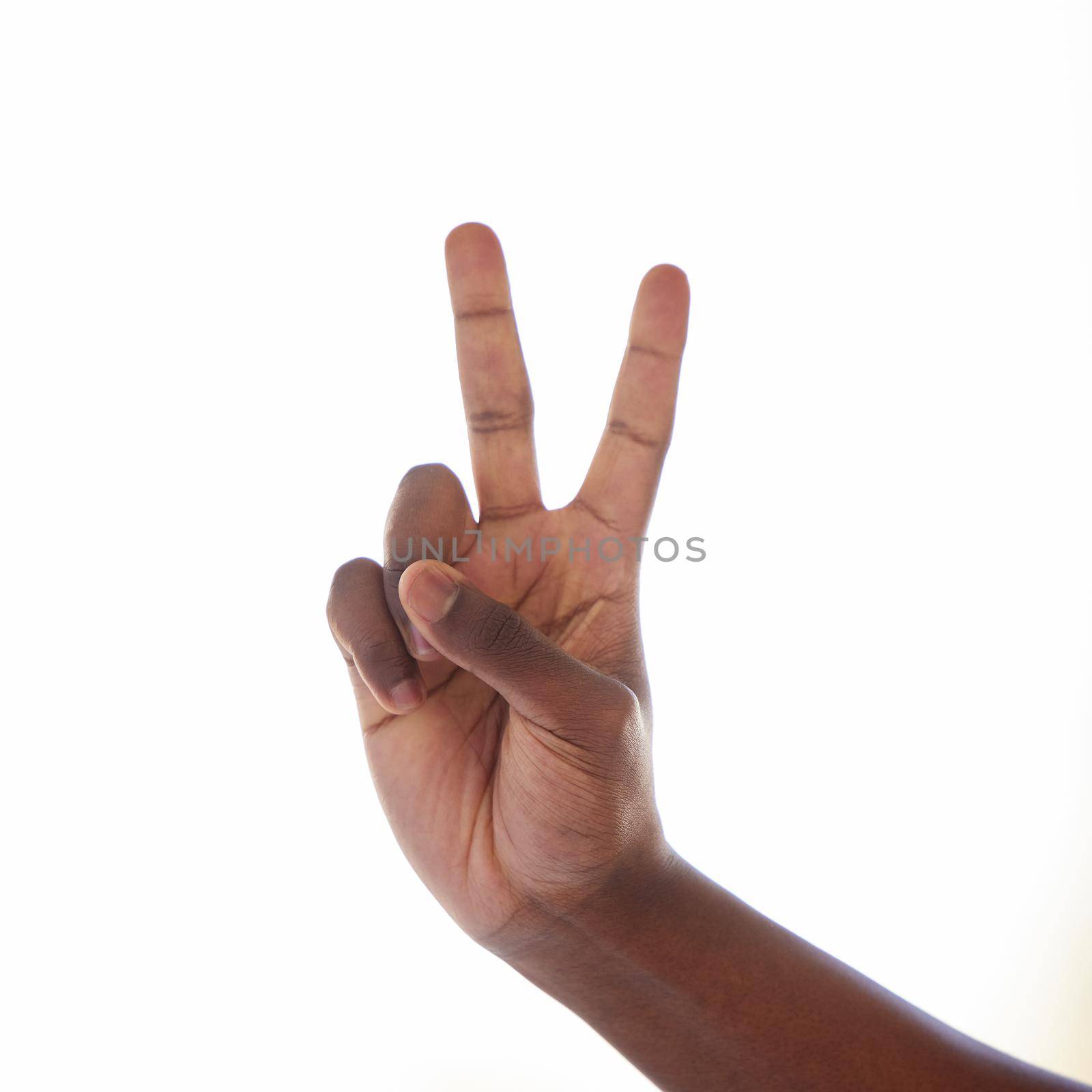 Studio shot of an unrecognisable man making a peace sign against a white background.