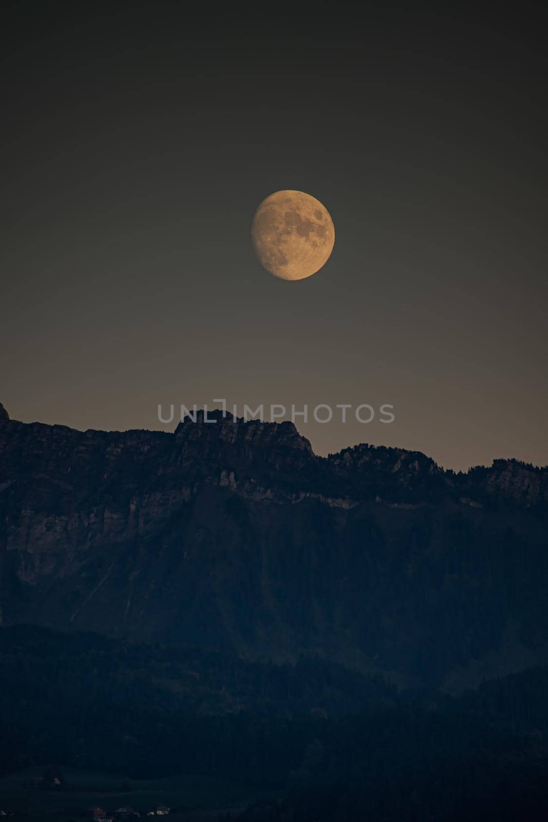 Moon rise infront of swiss mountains. High quality photo