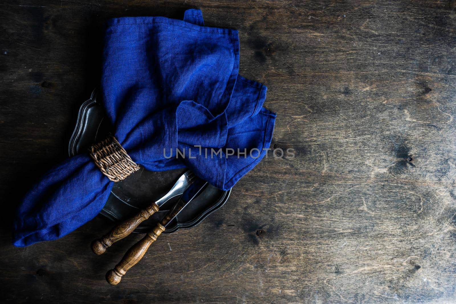 Place setting with vintage cutlery set on wooden table