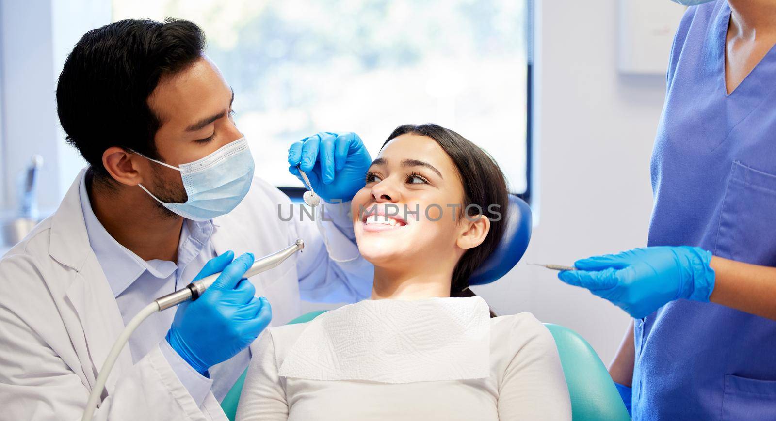 a young woman having a dental procedure performed on her.