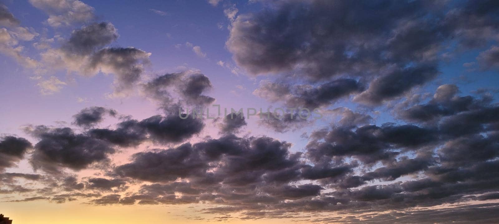 image of colorful sky with dark clouds in late afternoon in Brazil