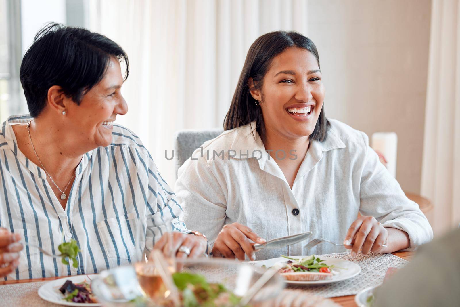 Its always jolly over here. a family having lunch together at home. by YuriArcurs