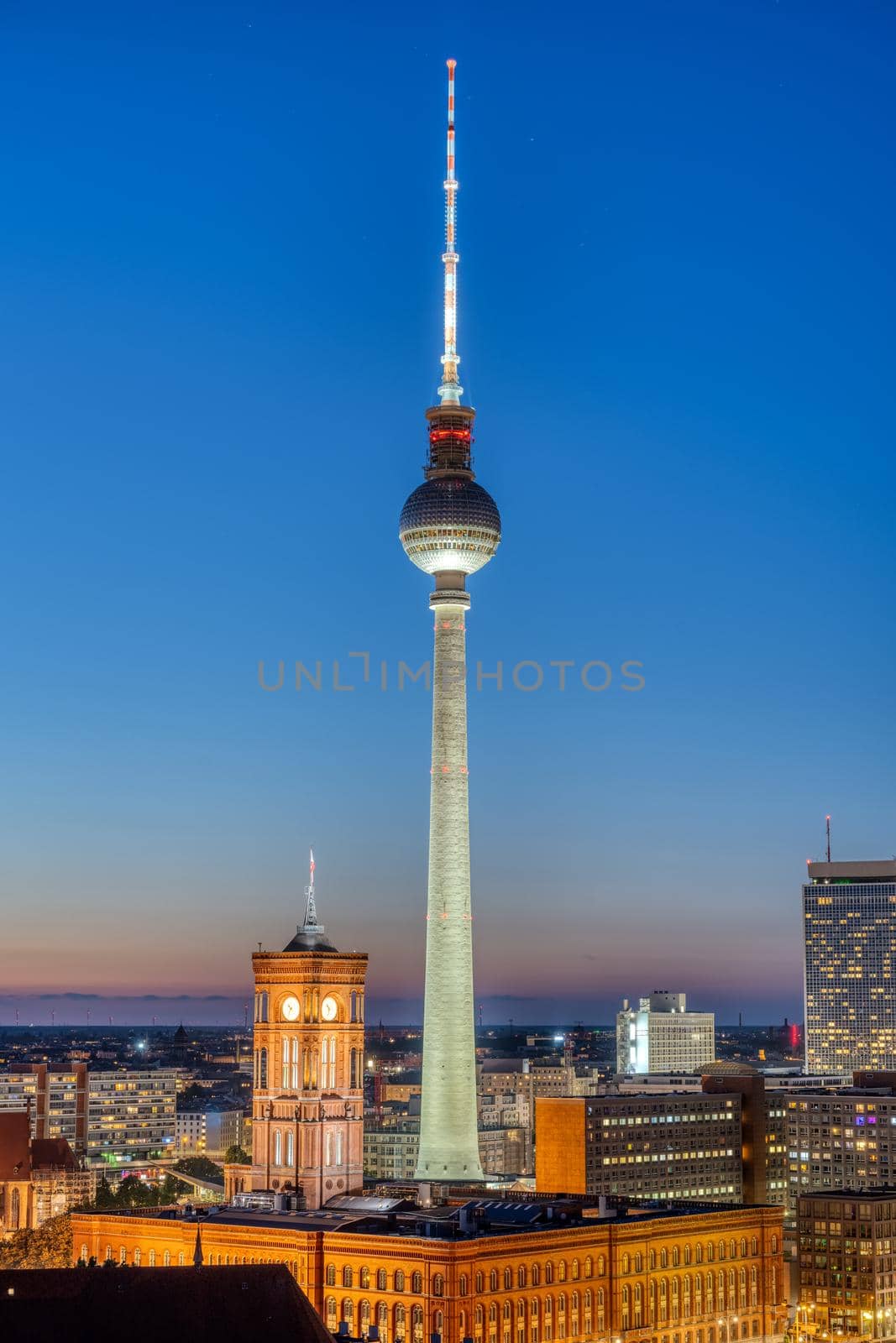 The iconic TV Tower of Berlin with the town hall at night