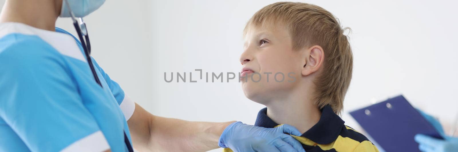 Female pediatrician listening to boy kid breathing with stethoscope tool, appointment at doctor by kuprevich