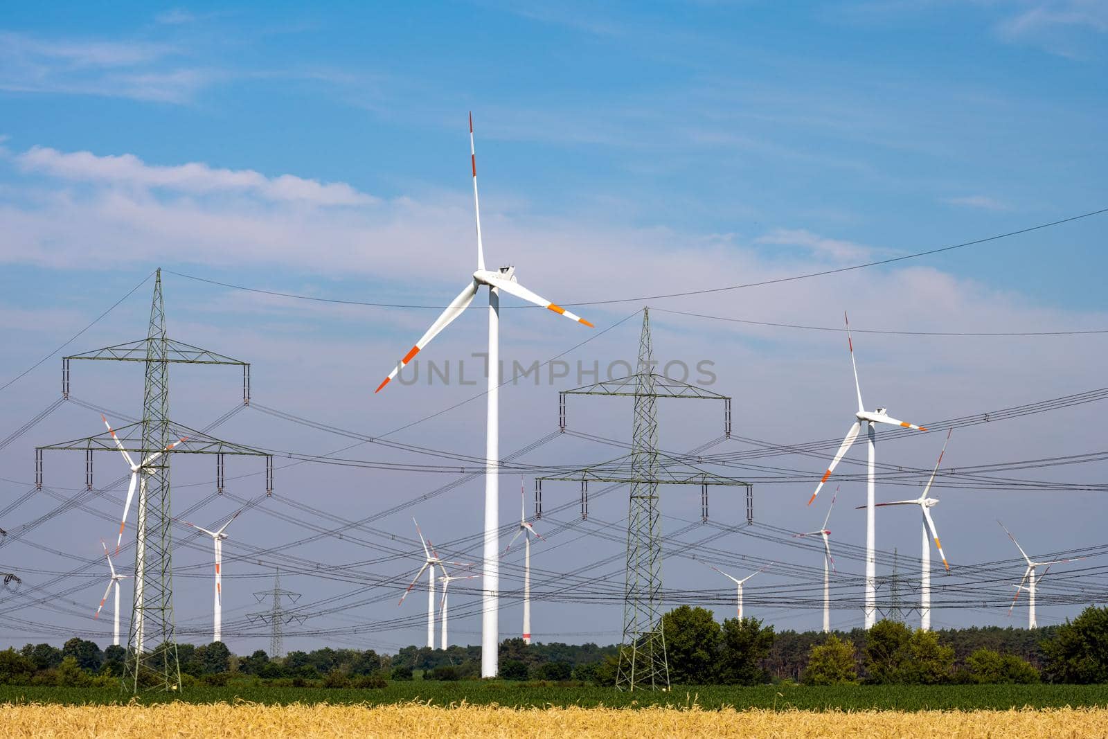 Various power lines and wind turbines seen in Germany