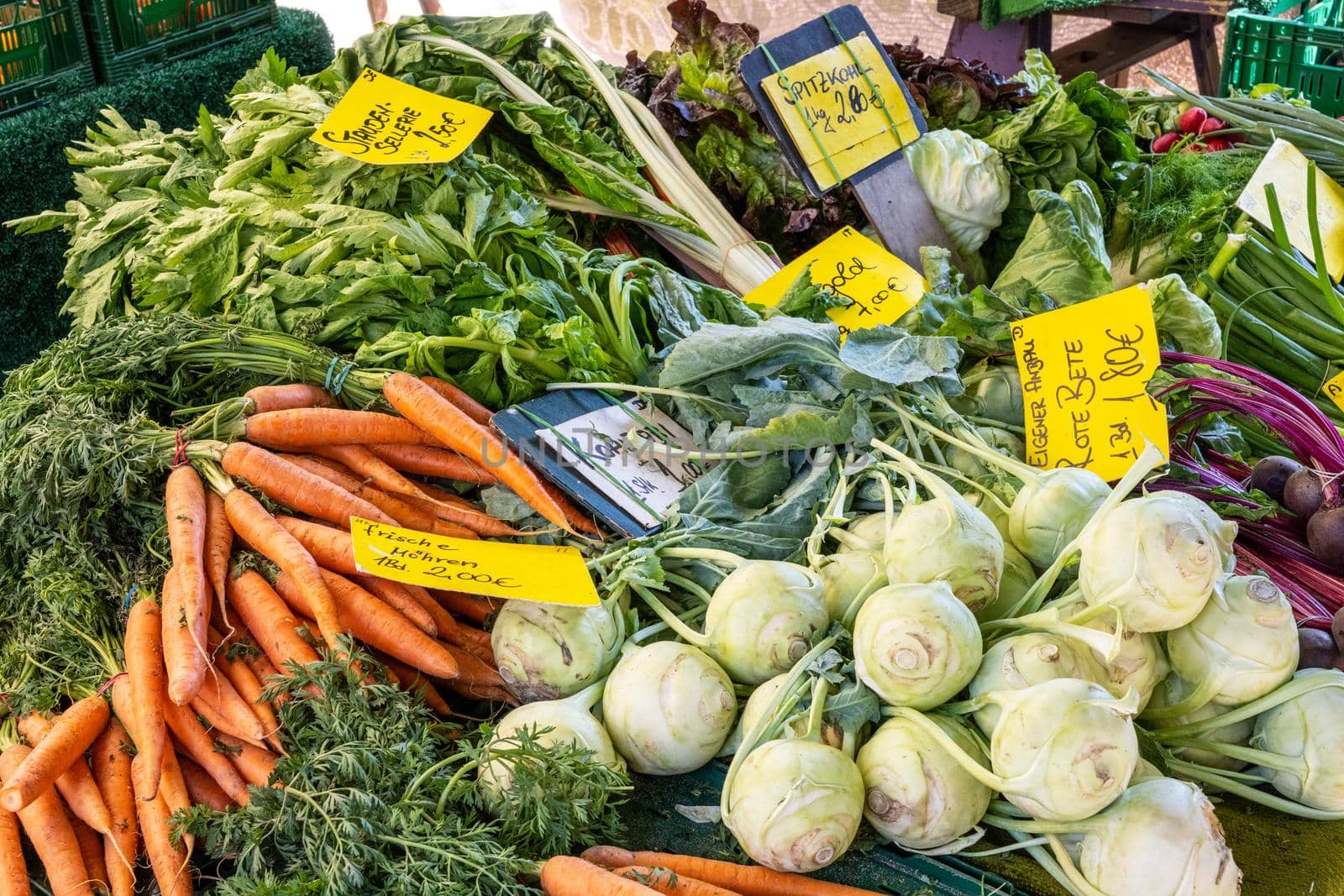 Kohlrabi, carrots and other vegetables for sale at a market