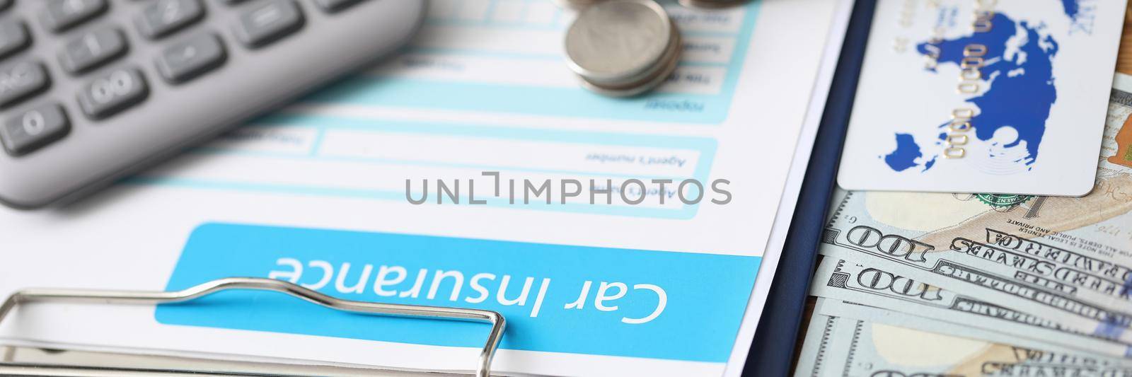 Close-up of car insurance paper calculator stack of coins and banknote on desk. Sign contract and protect your car from accident. Vehicle insurance concept