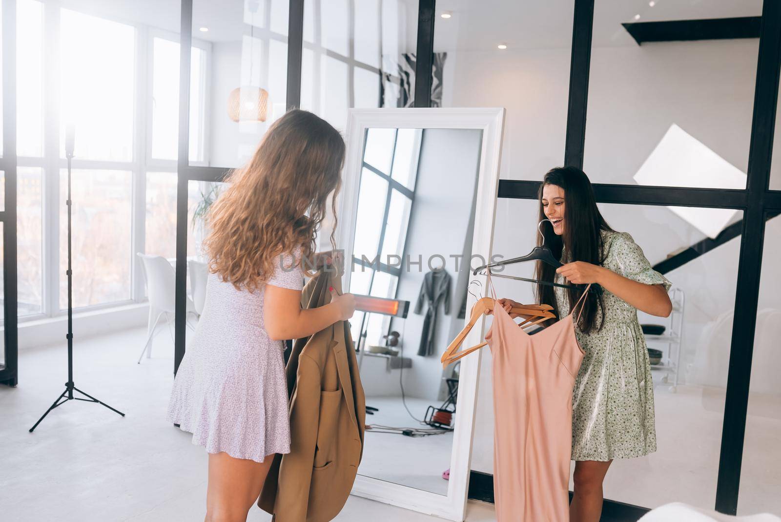 Image of pretty females trying on dress at home