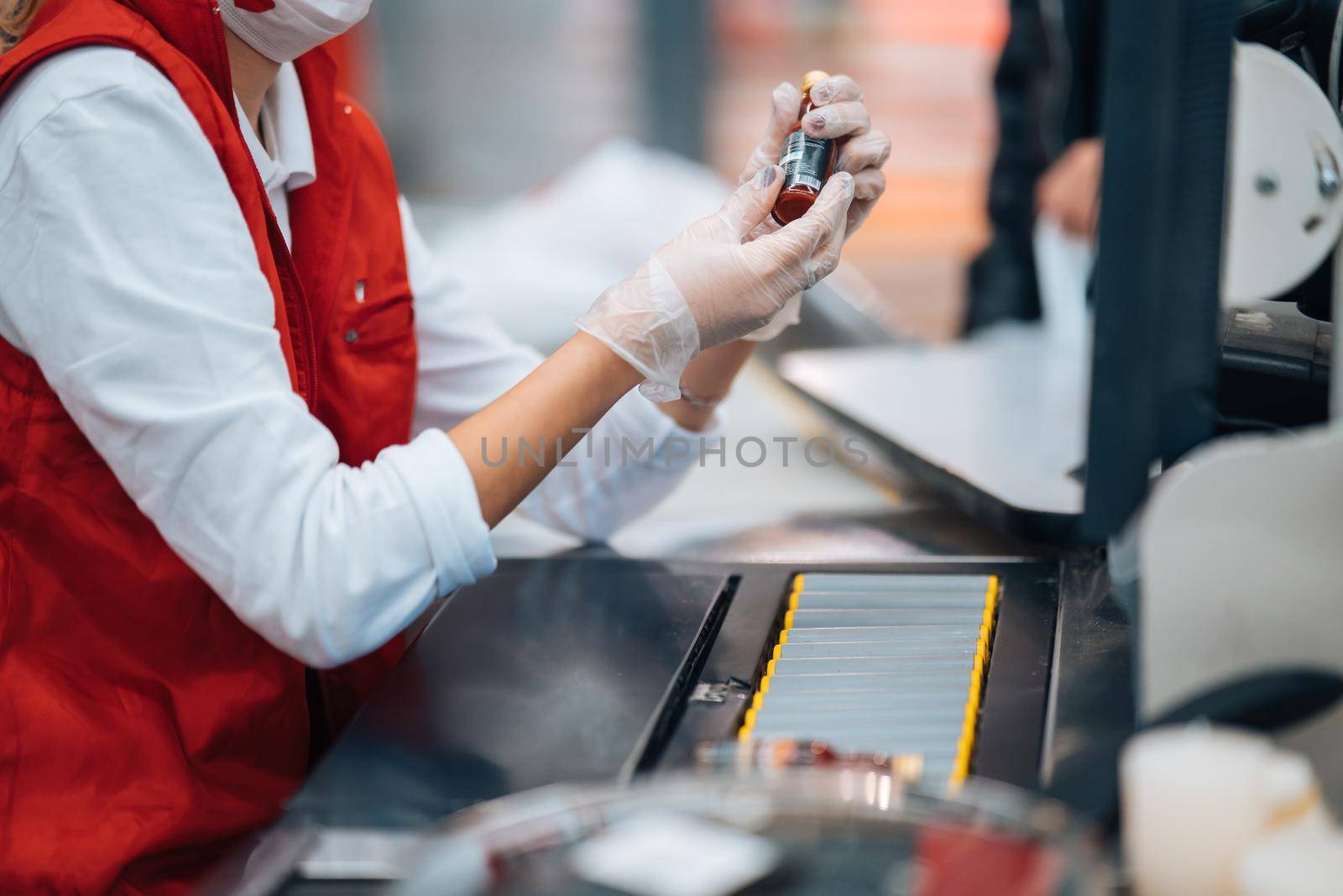 A woman reads the bar code at checkout machine