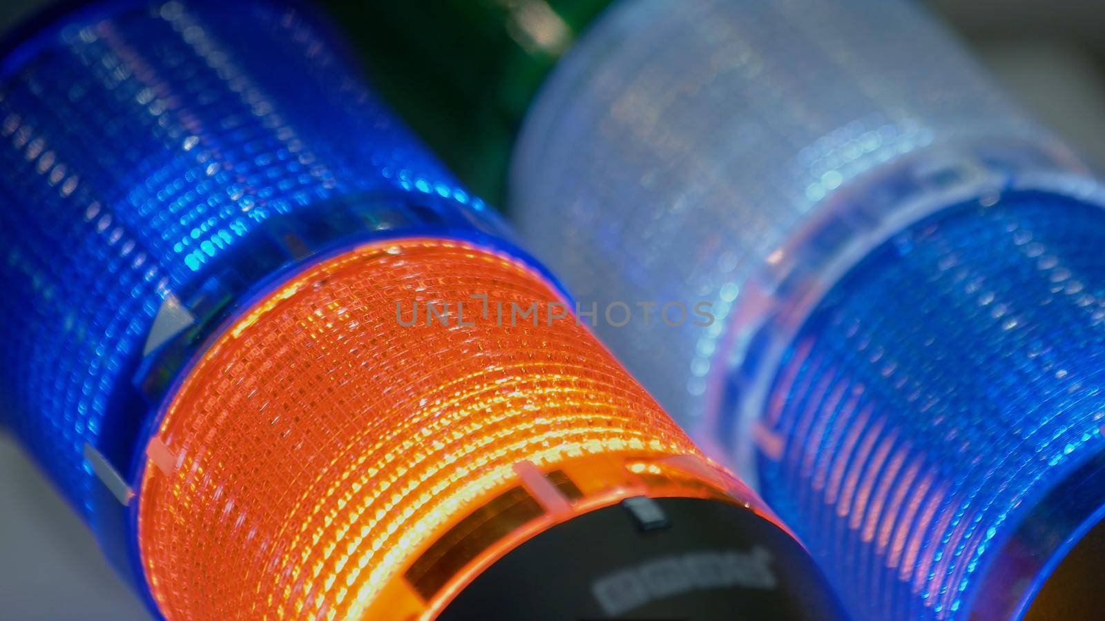 Blinking glowing LED diode light bulbs close-up. Illuminating blue and orange lights.