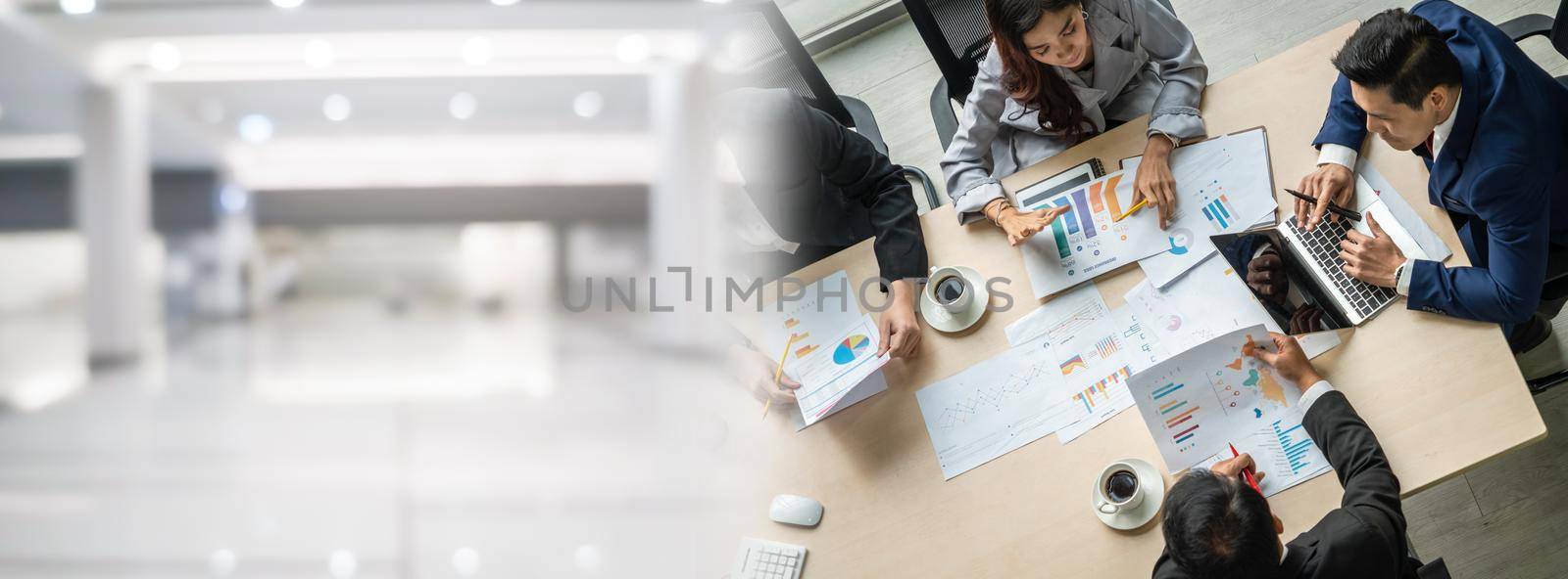 Business people group meeting shot from top widen view in office . Profession businesswomen, businessmen and office workers working in team conference with project planning document on meeting table .