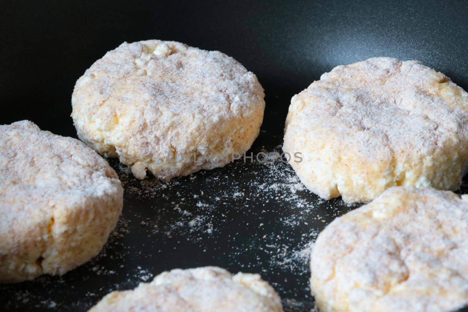 Cheesecakes are fried in a frying pan. Light delicious breakfast