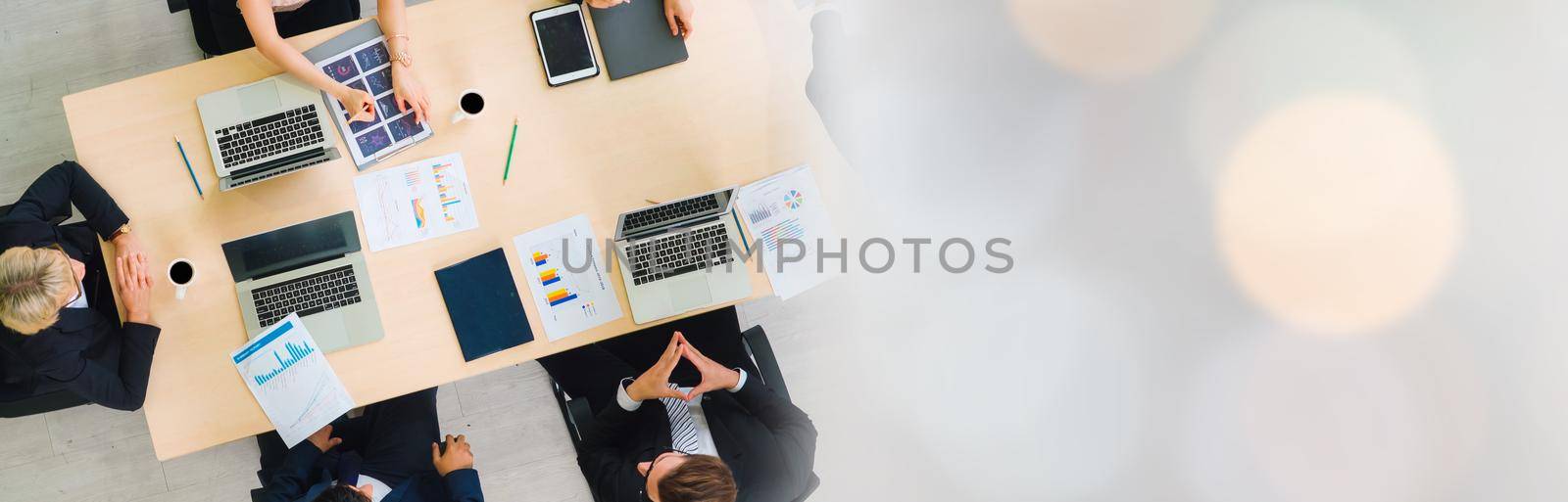 Business people group meeting shot from top widen view in office . Profession businesswomen, businessmen and office workers working in team conference with project planning document on meeting table .