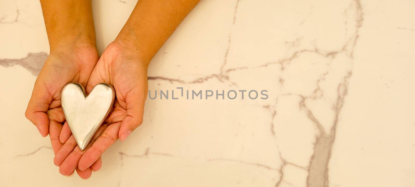 romantic background of iron shiny heart with marble and leaf