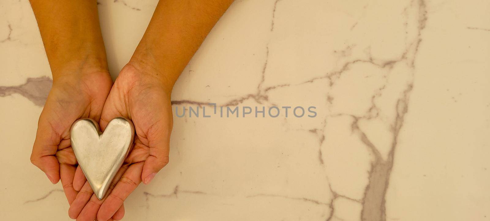 romantic background of iron shiny heart with marble and leaf by sarsa