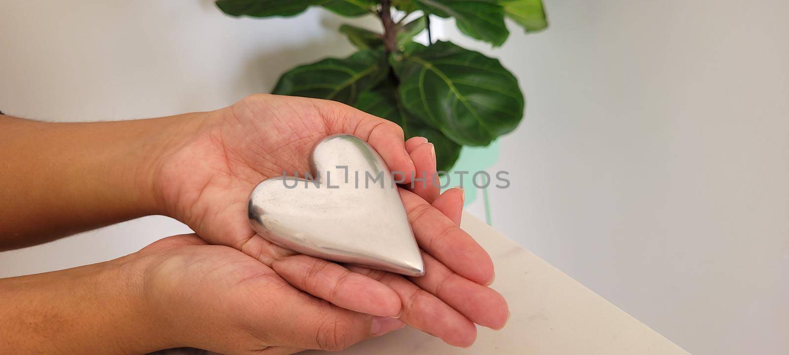 romantic background of iron shiny heart with marble and leaf