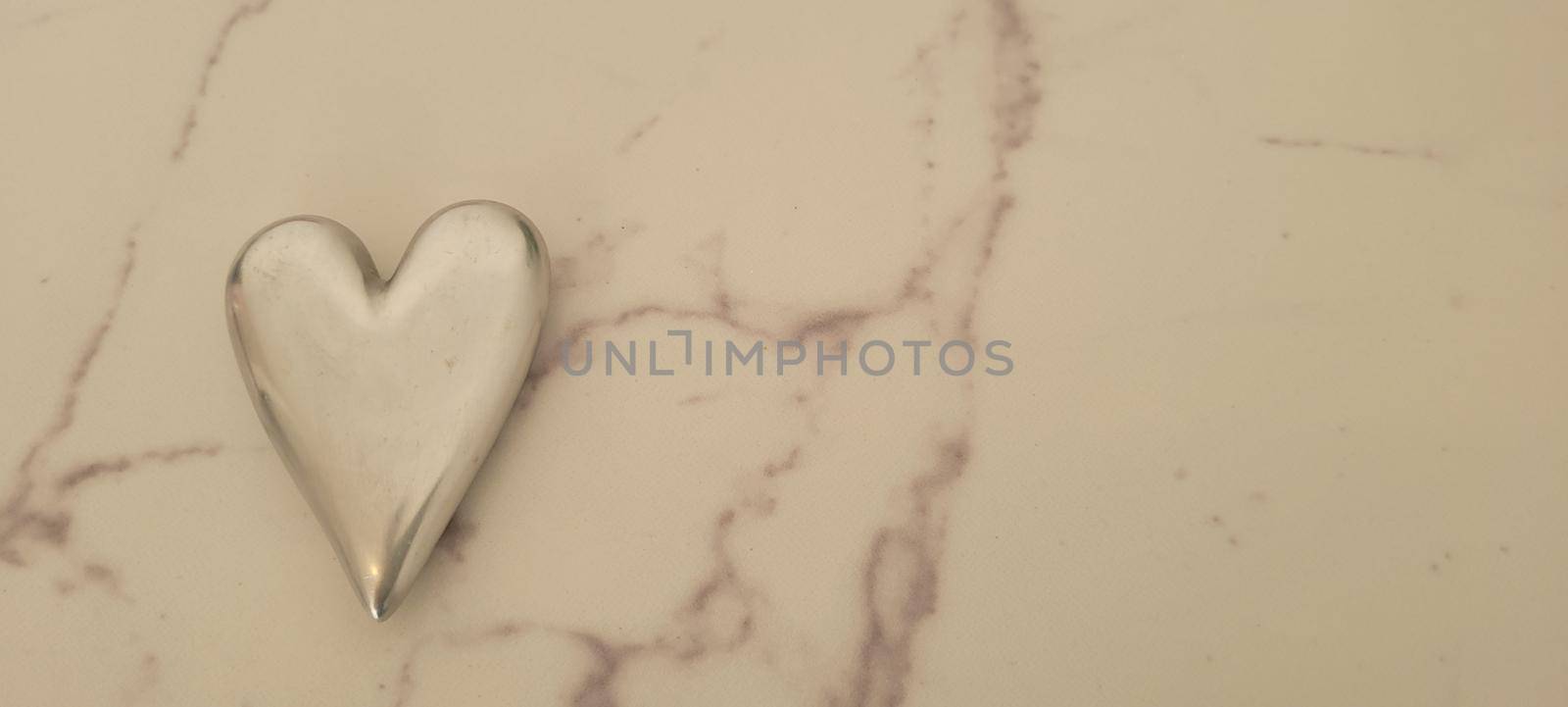 romantic background of iron shiny heart with marble and leaf by sarsa