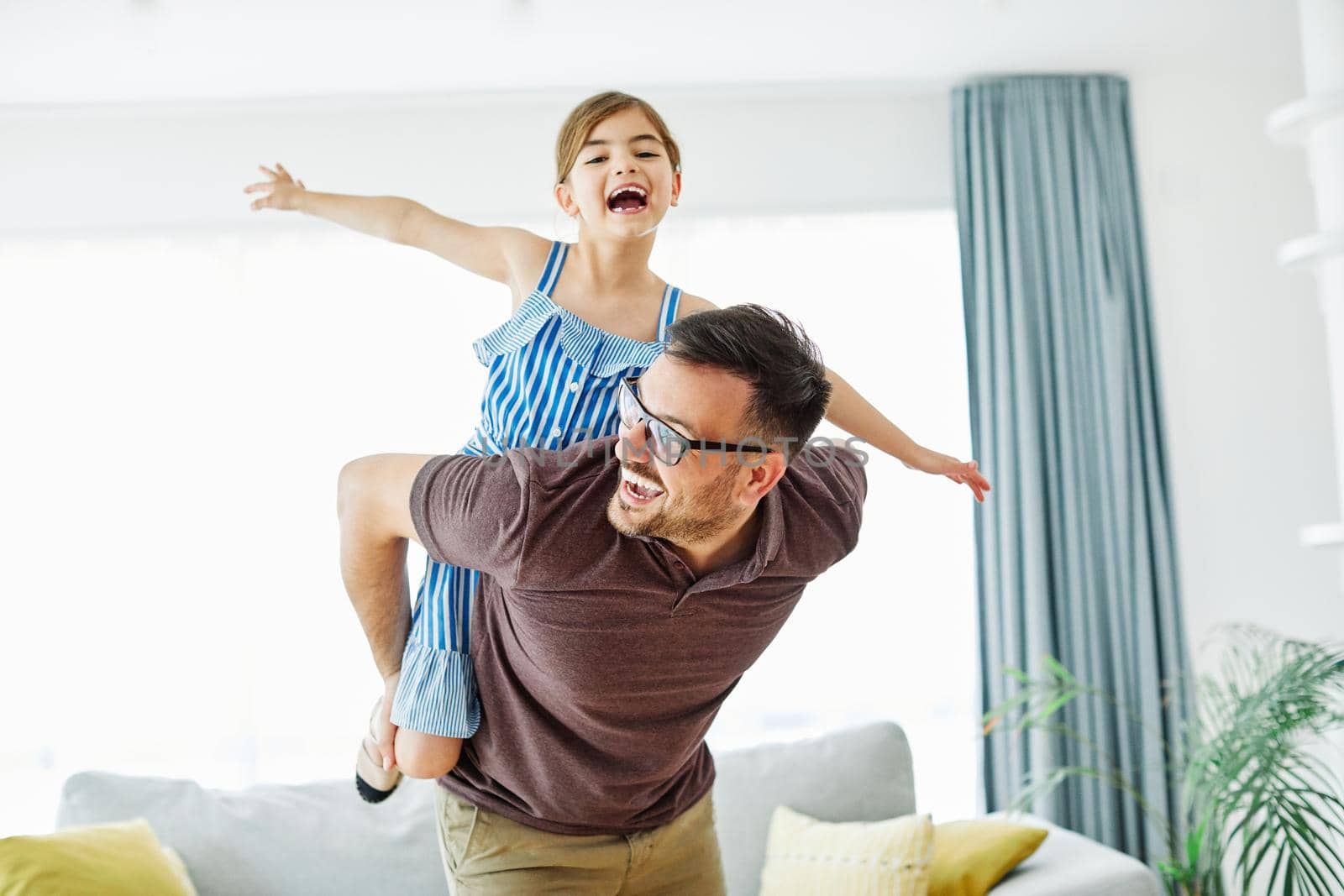 Family father and daughter having fun playing at home