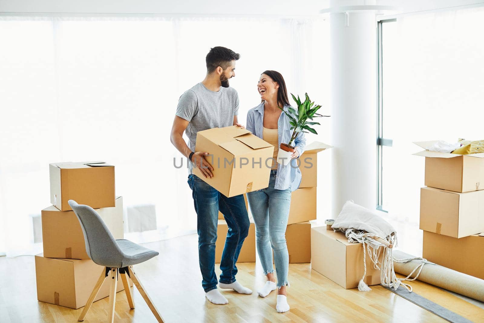 woman couple man box home house moving happy apartment together romantic relocation new property by Picsfive