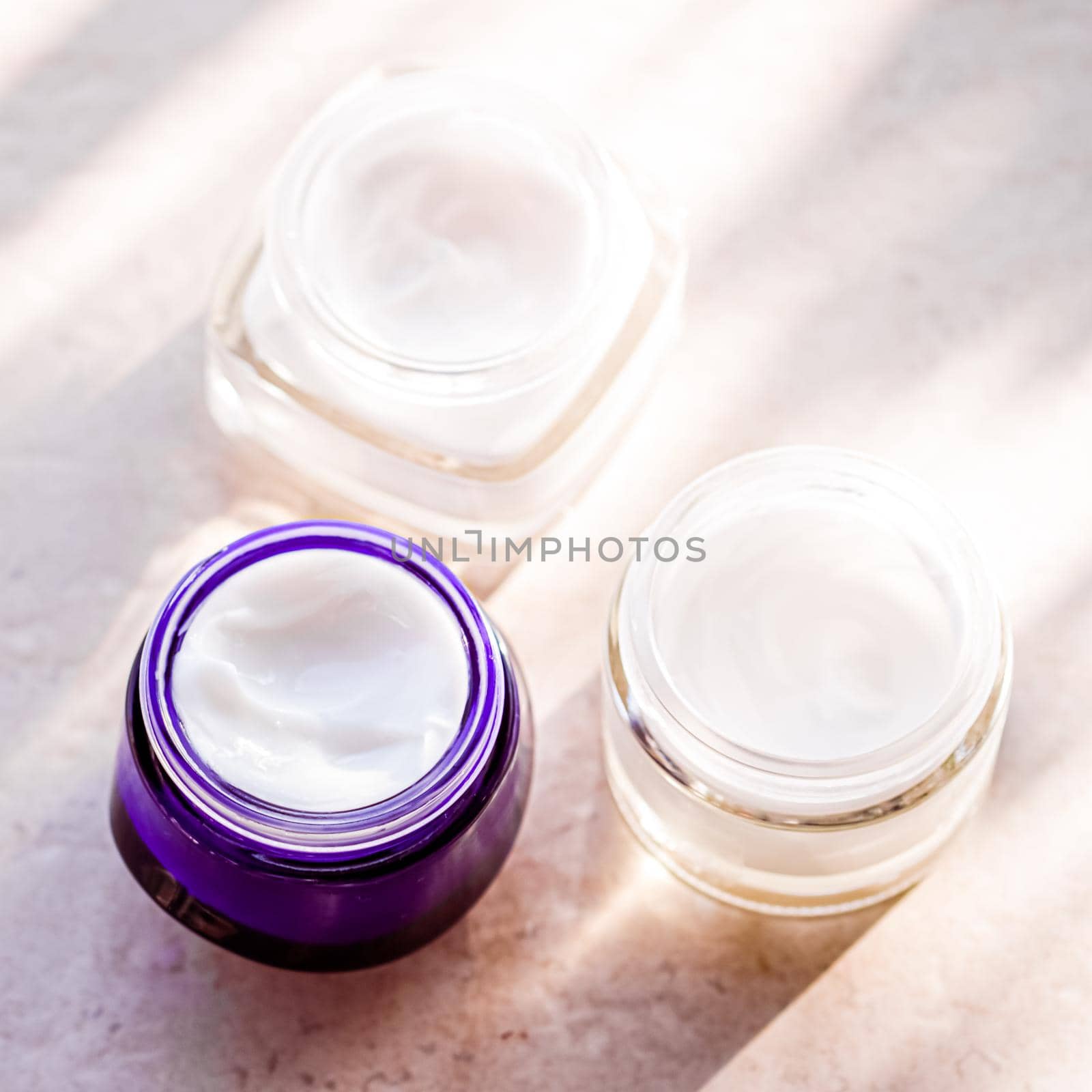 Moisturising beauty cream jars, skincare and spa cosmetics on stone background in summer at sunset, cosmetic product and skin care concept