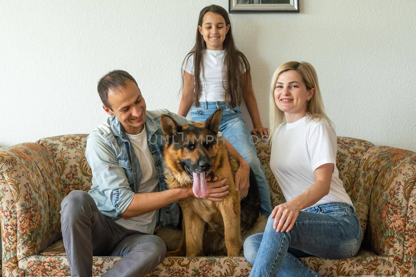 Portrait of happy family with a dog having fun together at home.