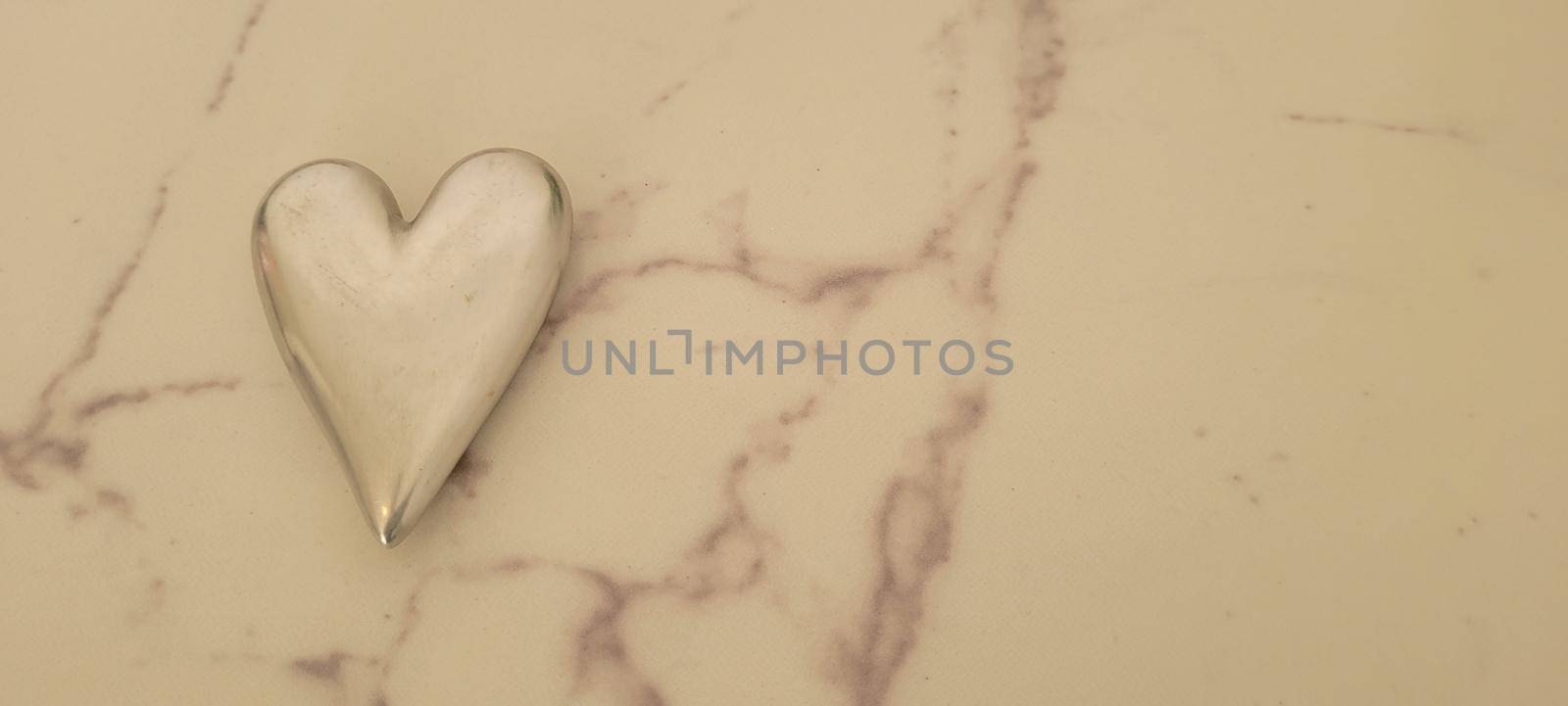 romantic background of iron shiny heart with marble and leaf