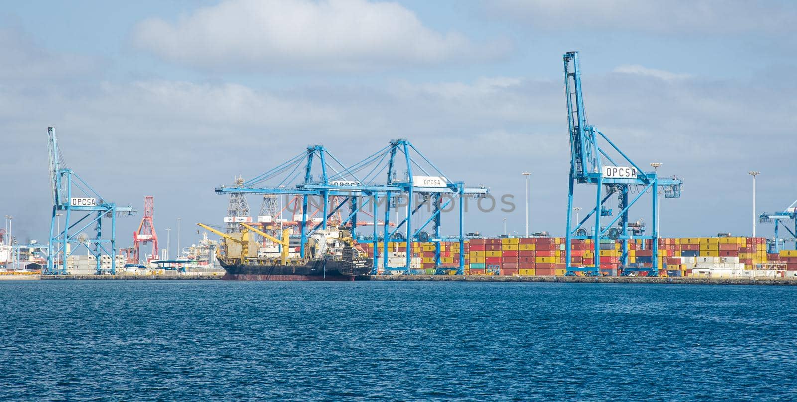 Picture of Las palmas Canary Island port with large ships carrying cargo, large container cranes and passenger ships