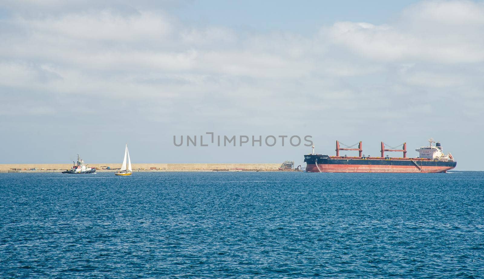 Picture of Las palmas Canary Island port with large ships carrying cargo, large container cranes and passenger ships
