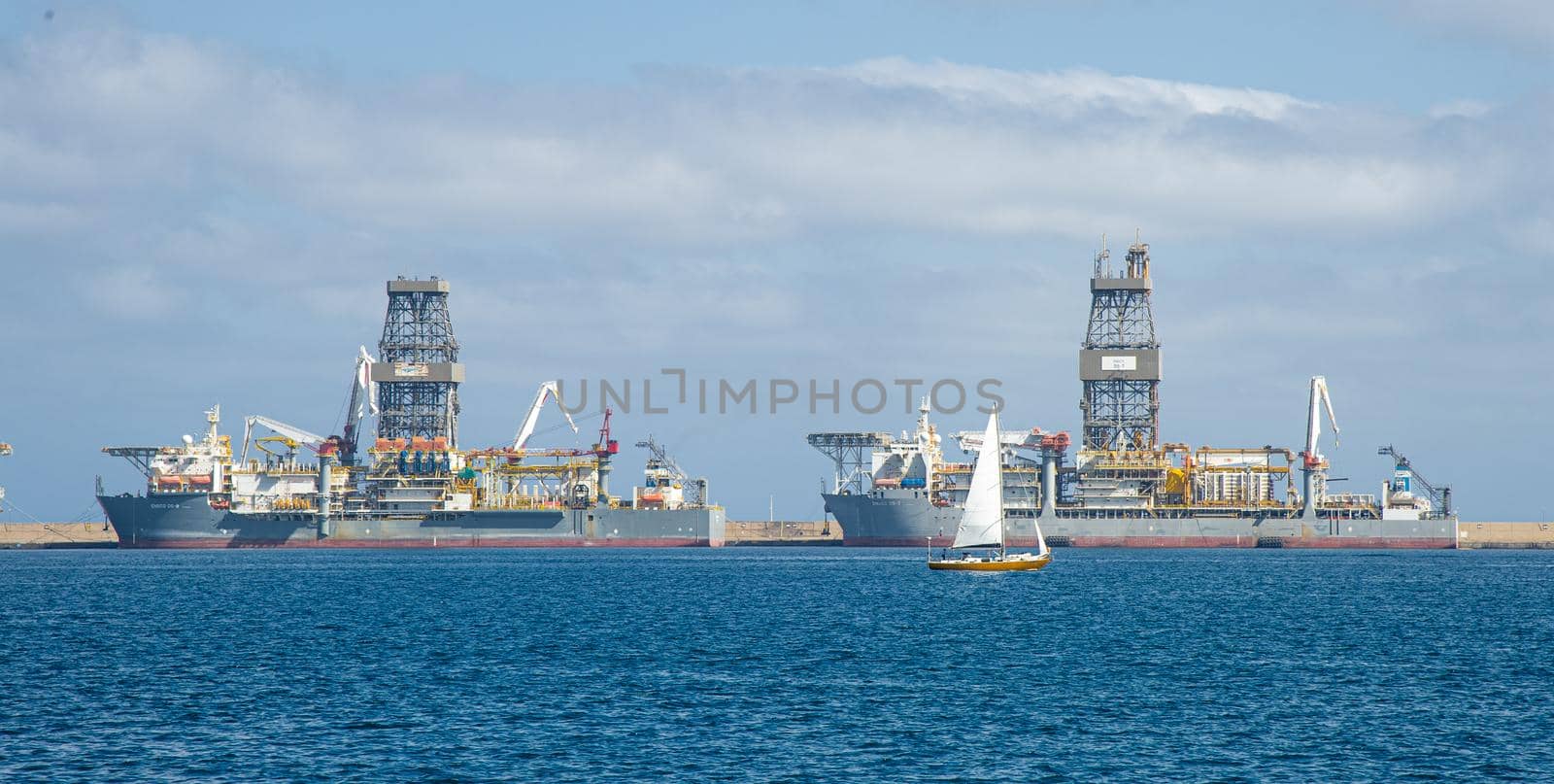 Picture of Las palmas Canary Island port with large ships carrying cargo, large container cranes and passenger ships