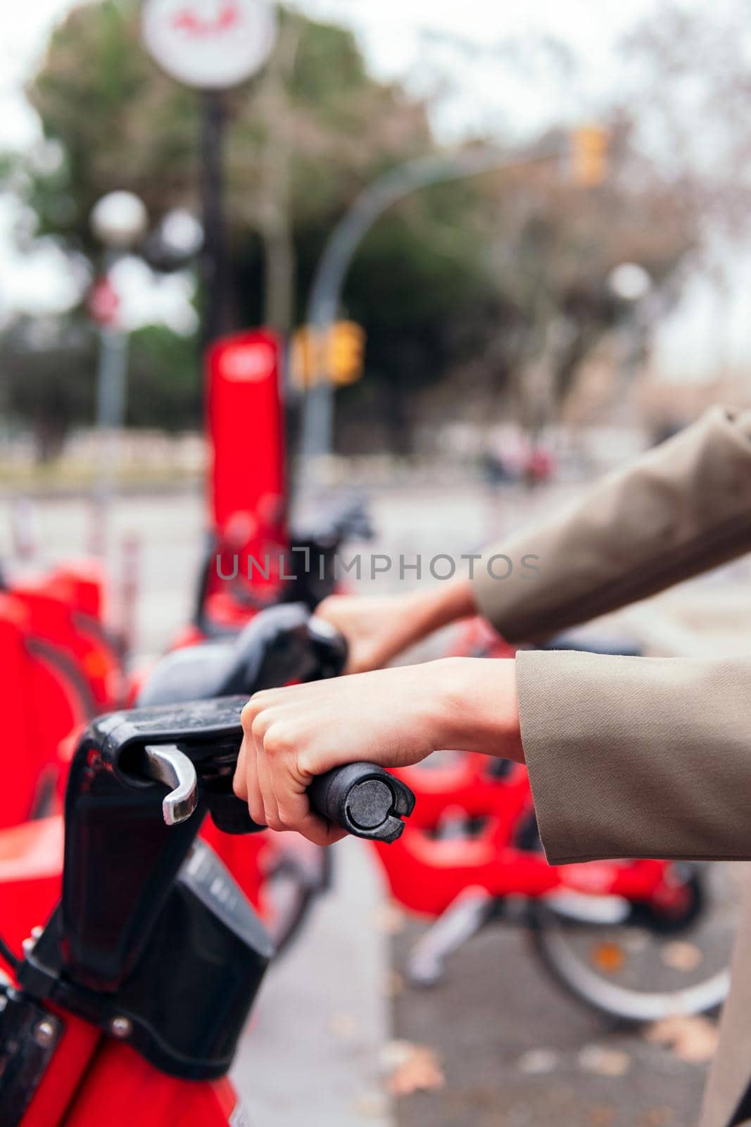 closeup of the hands of an unrecognizable person taking a bike from a rental station, active lifestyle and sustainable mobility concept, copy space for text