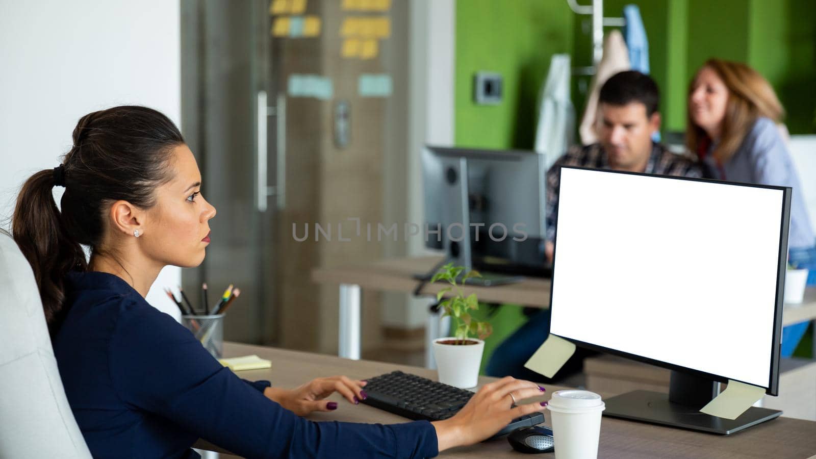 Beautiful caucasian businesswoman looking at isolated computer screen by DCStudio
