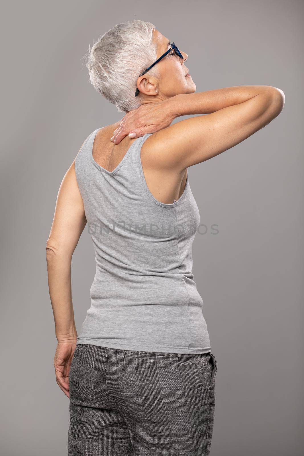 Backache pain in back, senior woman with  body and muscle problems by adamr