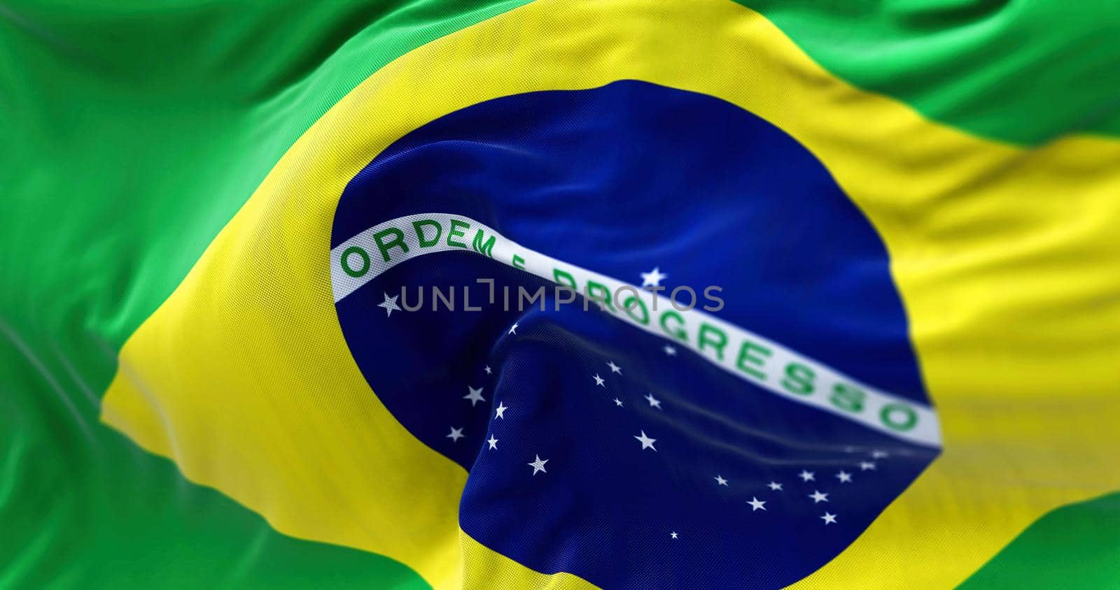 Close-up view of the Brazilian national flag waving in the wind. Brazil is a South American country.