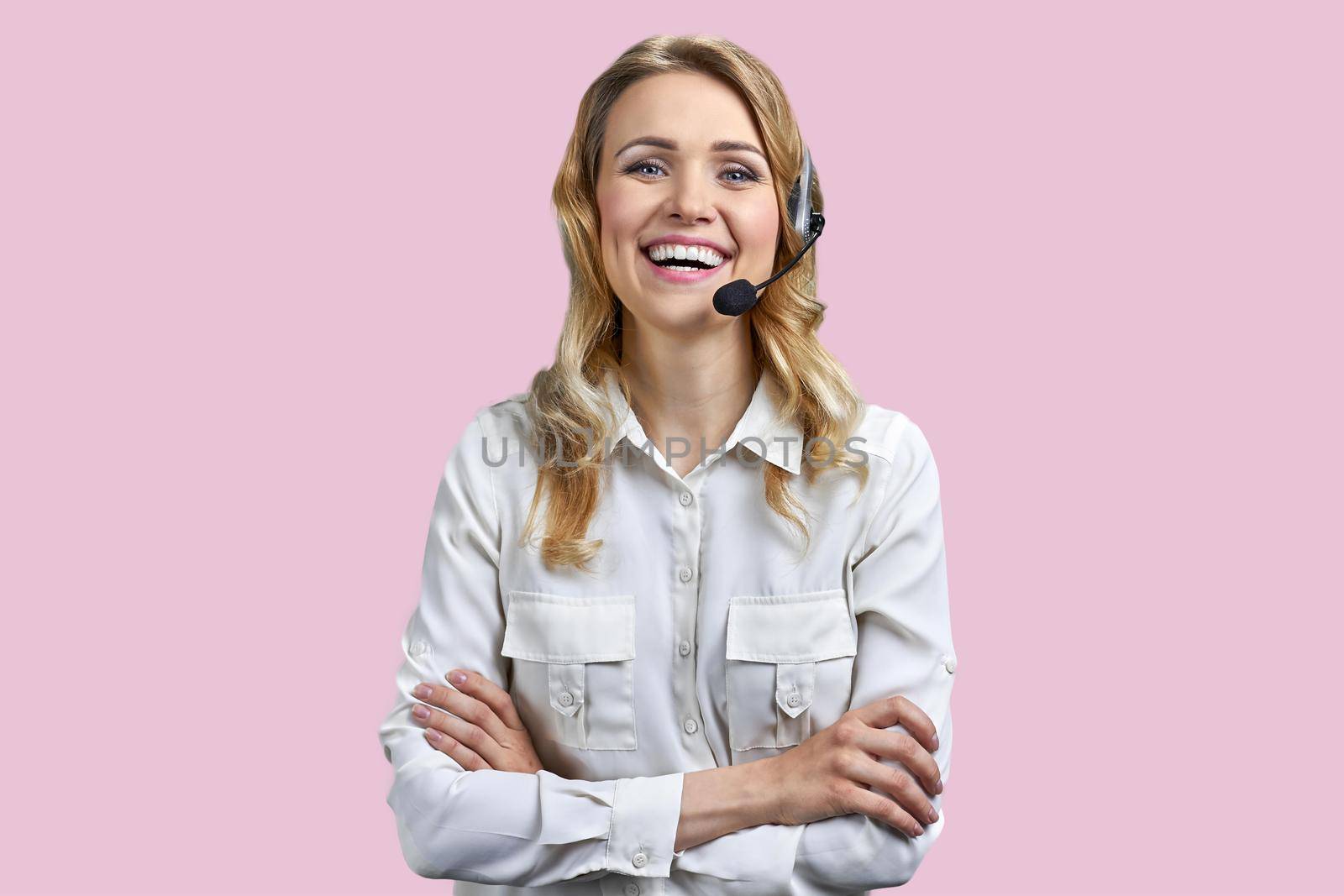 Portrait of happy smiling call center agent looking at camera. Call center operator with headset on color background.