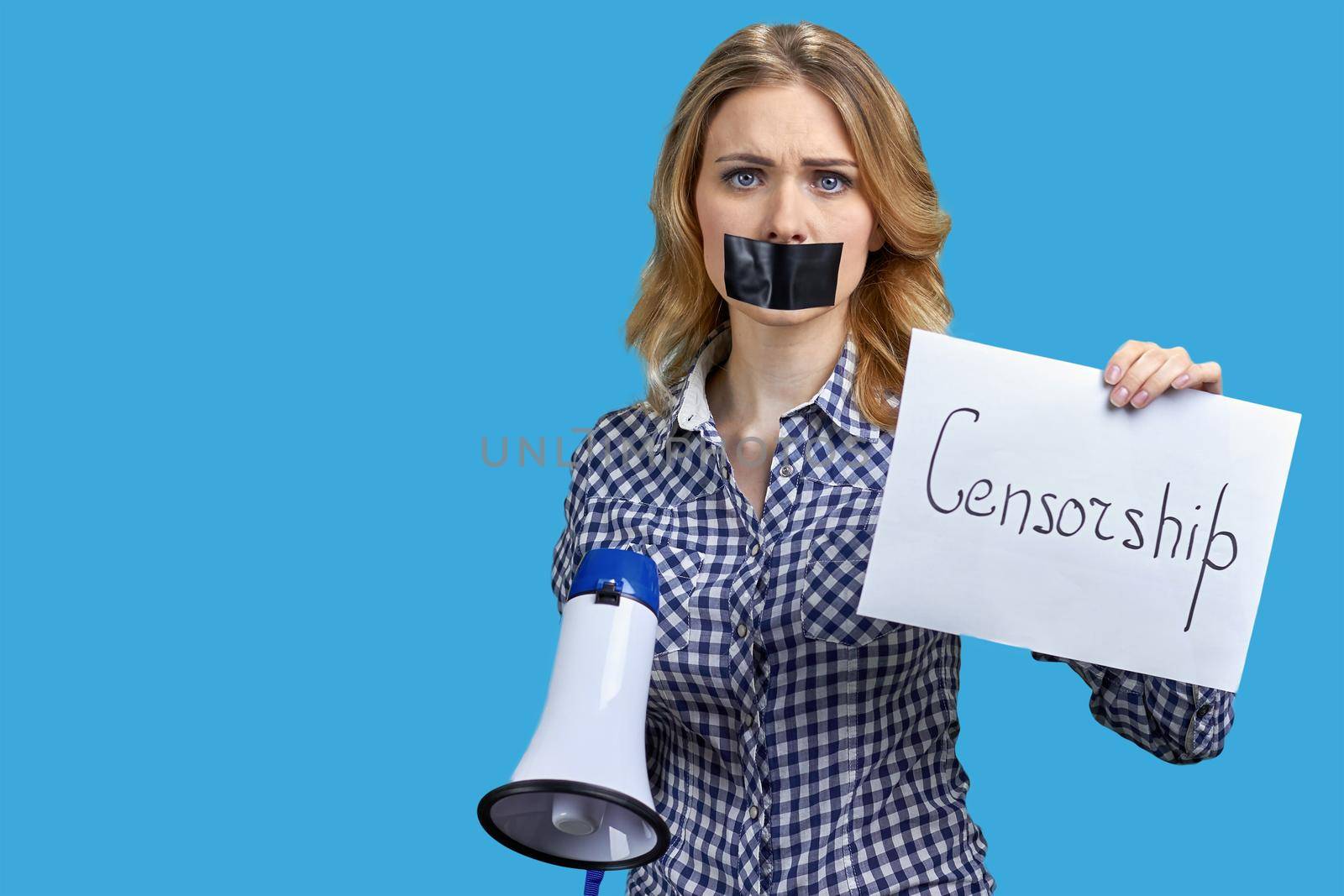 Young woman with covered mouth holding card with inscription Censorship. Woman with taped mouth on color background.