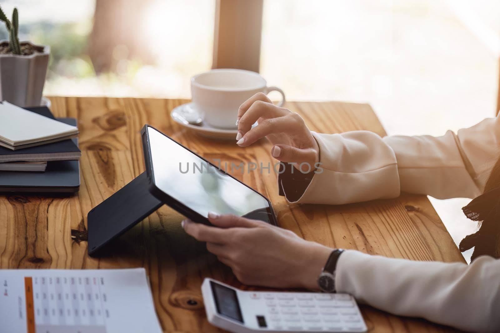 Portrait of a business woman using a tablet computer for data analysis, marketing, accounting by Manastrong