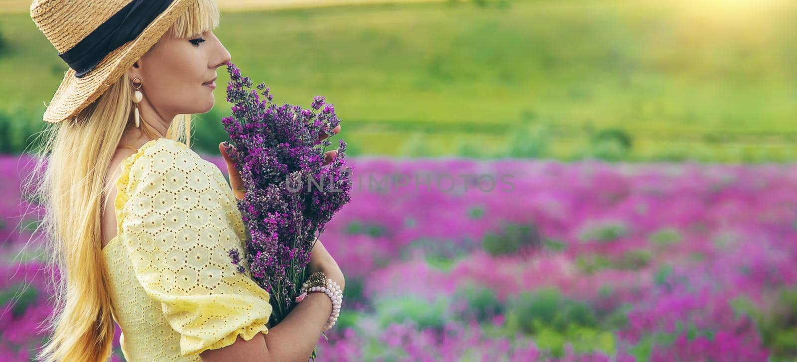 Beautiful woman in lavender field. Selective focus. Nature.