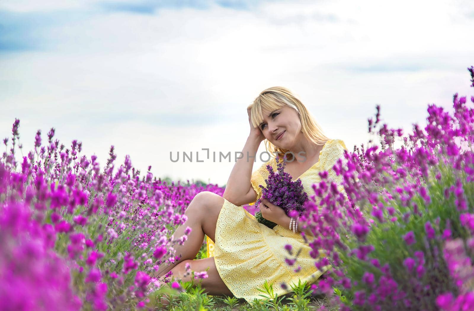 Beautiful woman in lavender field. Selective focus. Nature.