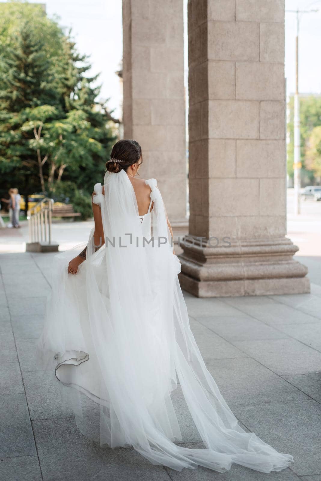 young woman bride in white dress in urban atmosphere