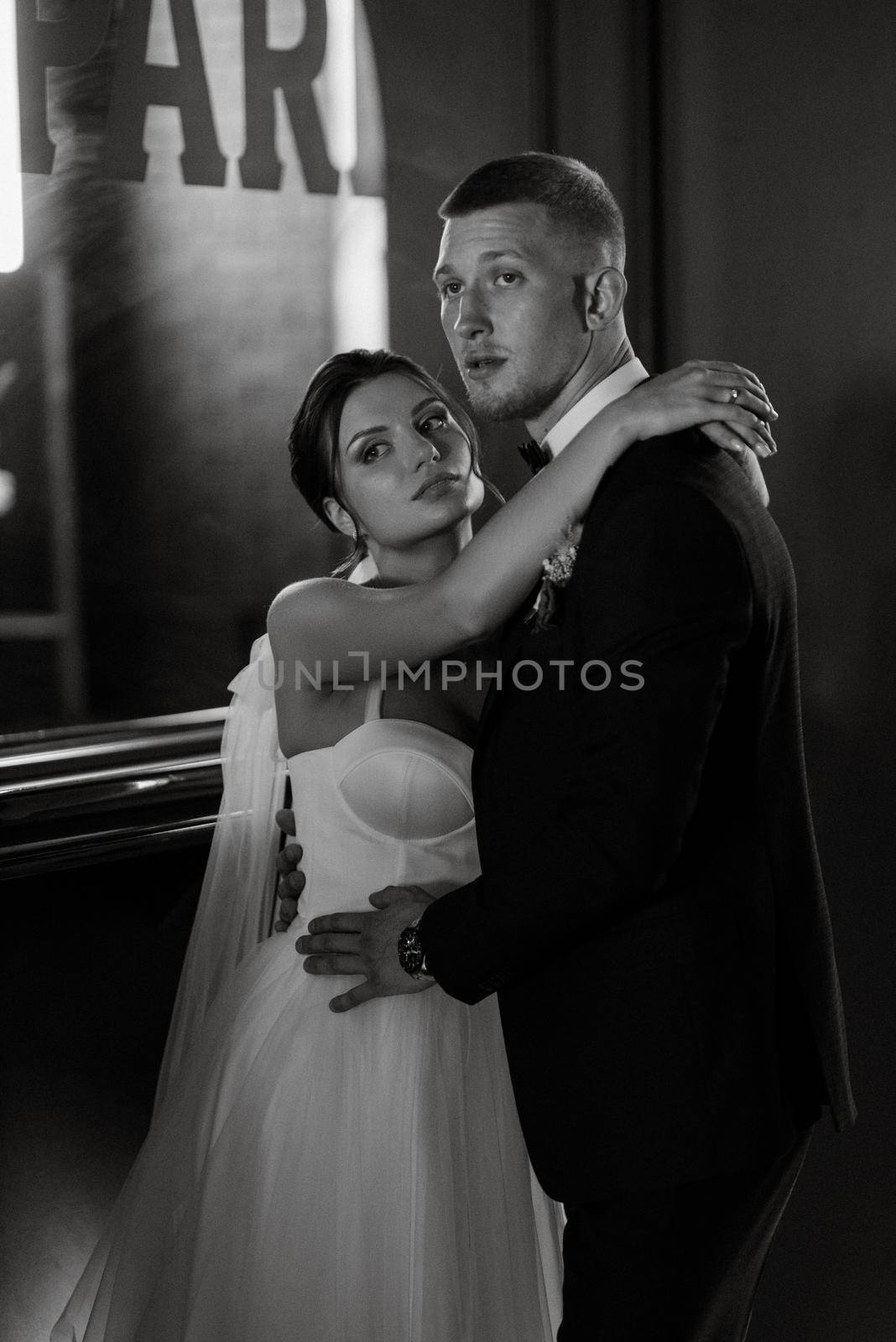 bride and groom inside a cocktail bar in a vibrant atmosphere