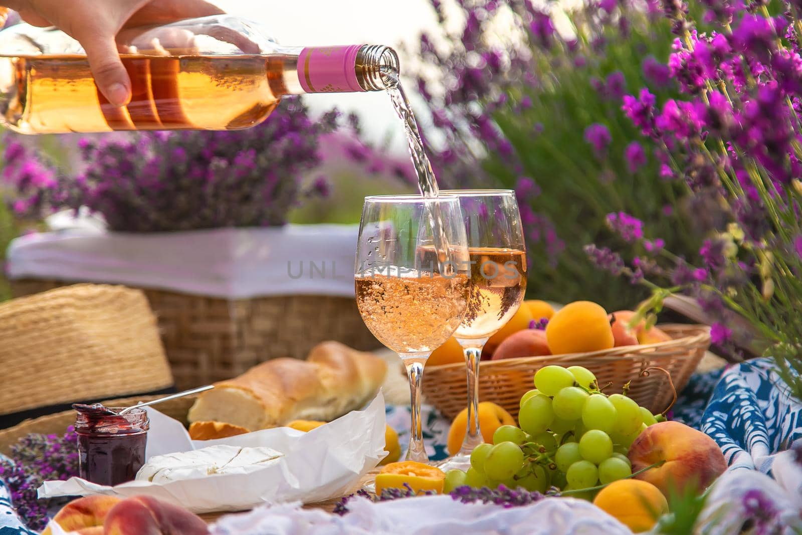 Wine in a lavender field. Selective focus. Food.