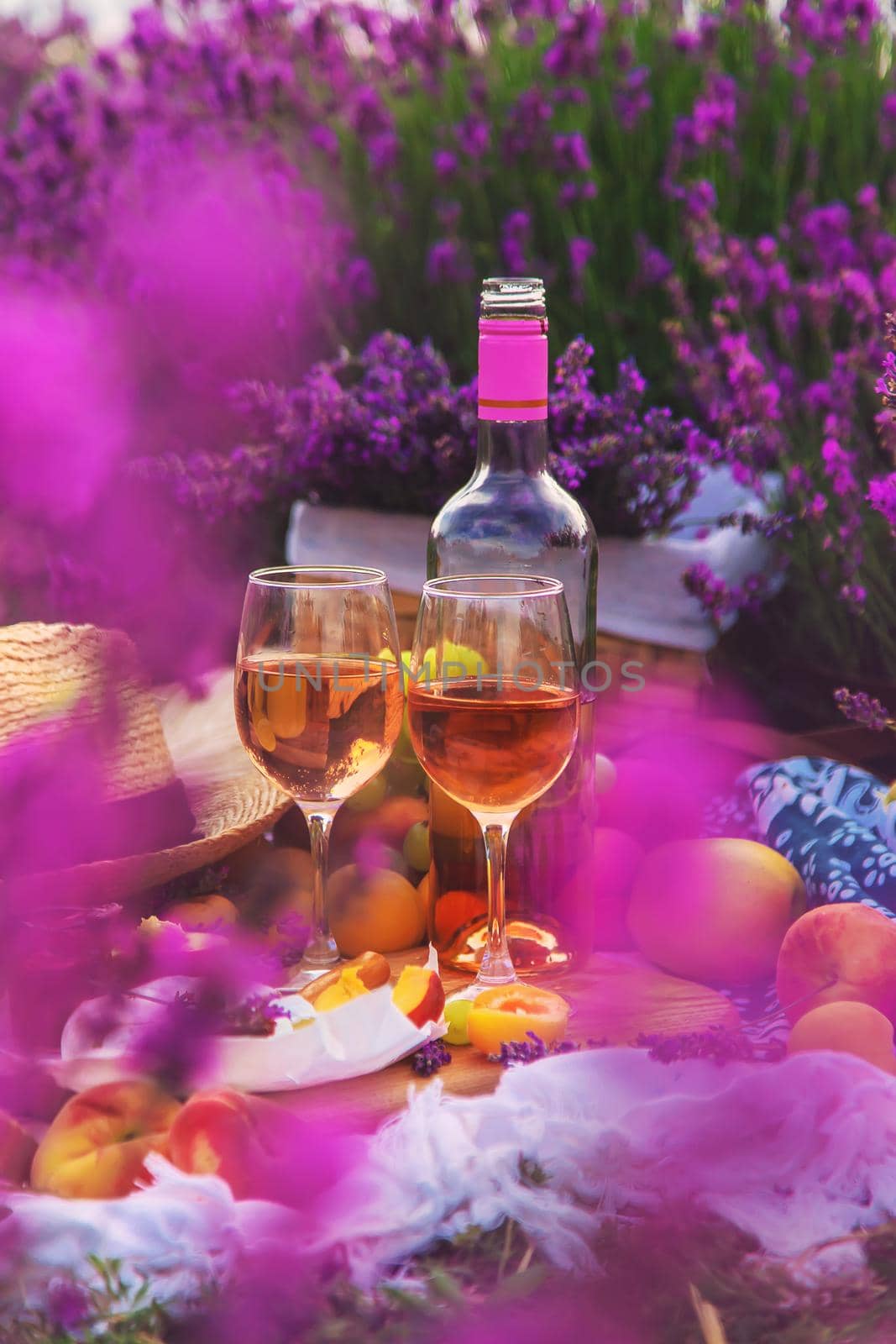 Wine in a lavender field. Selective focus. Food.