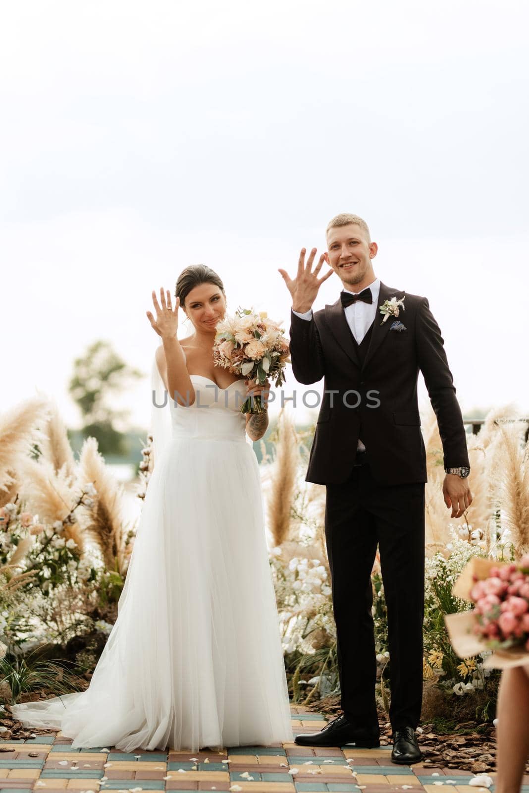 wedding ceremony on a high pier near the river with invited guests