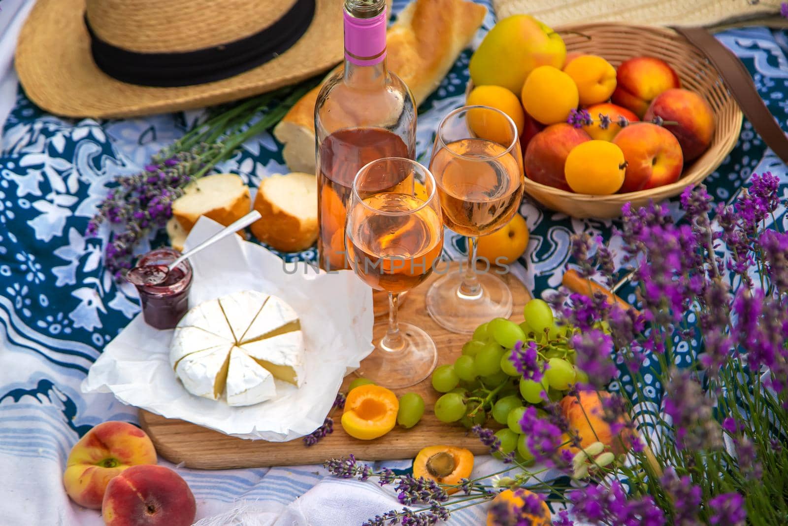 Wine in a lavender field. Selective focus. Food.