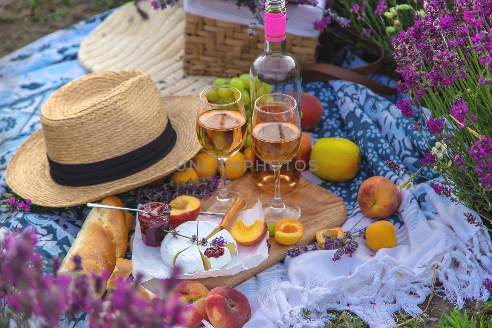 Wine in a lavender field. Selective focus. Food.