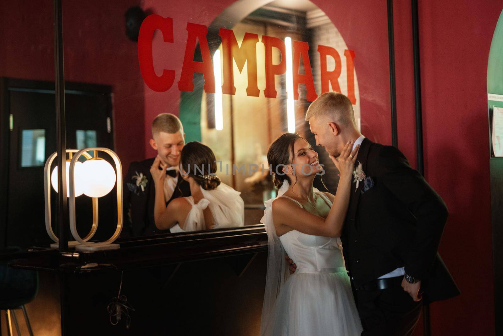 bride and groom inside a cocktail bar in a vibrant atmosphere