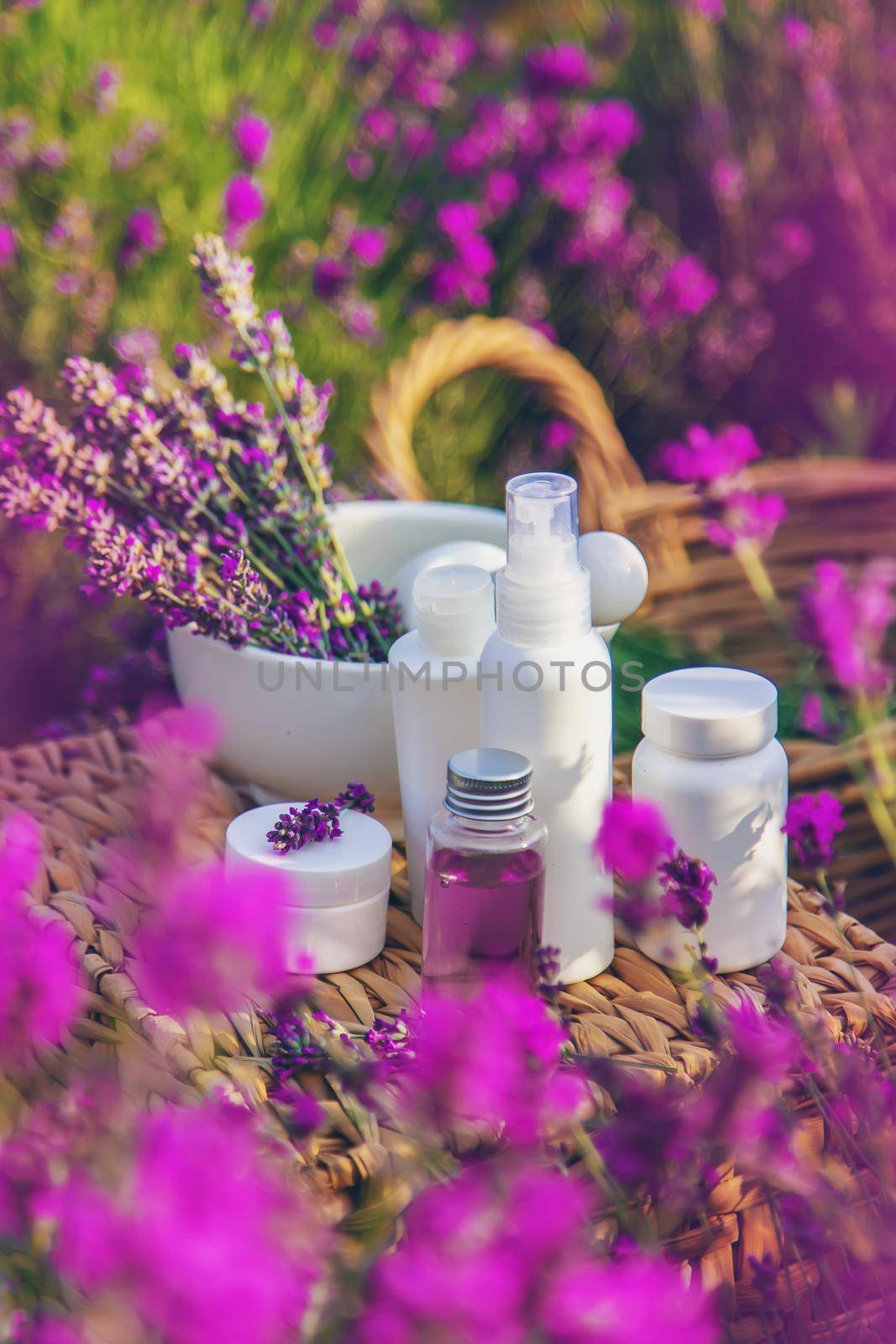 Lavender cosmetics in a field with flowers. Selective focus. Nature.