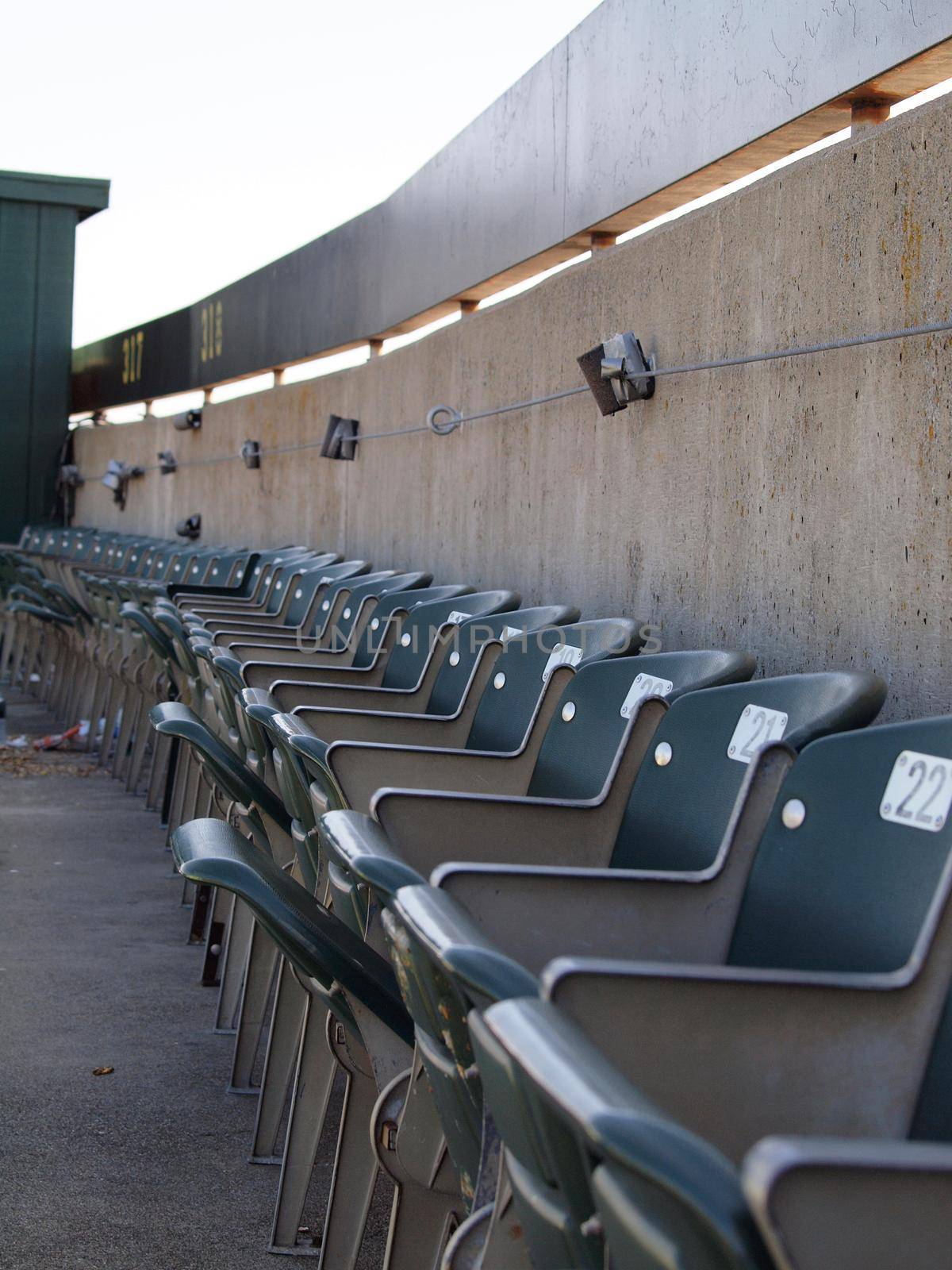 Row of green seats in the top row of the upperdeck of stadium