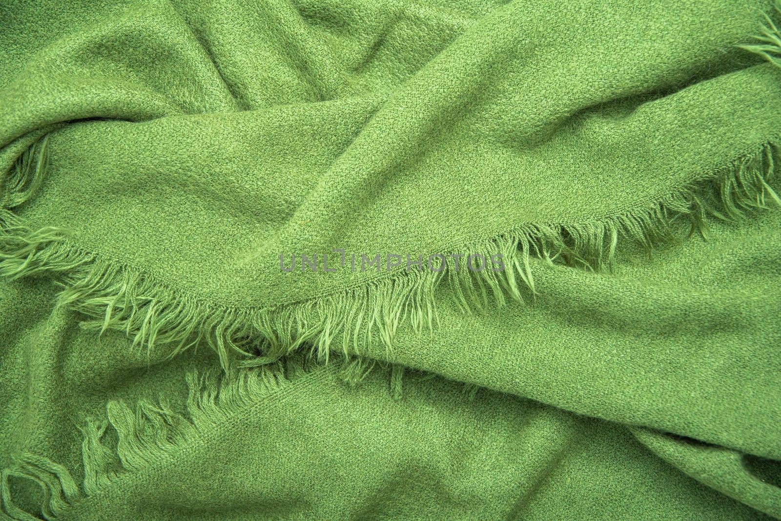 bright green scarf with fringe, natural background, fashion accessory for autumn for woman. High quality photo