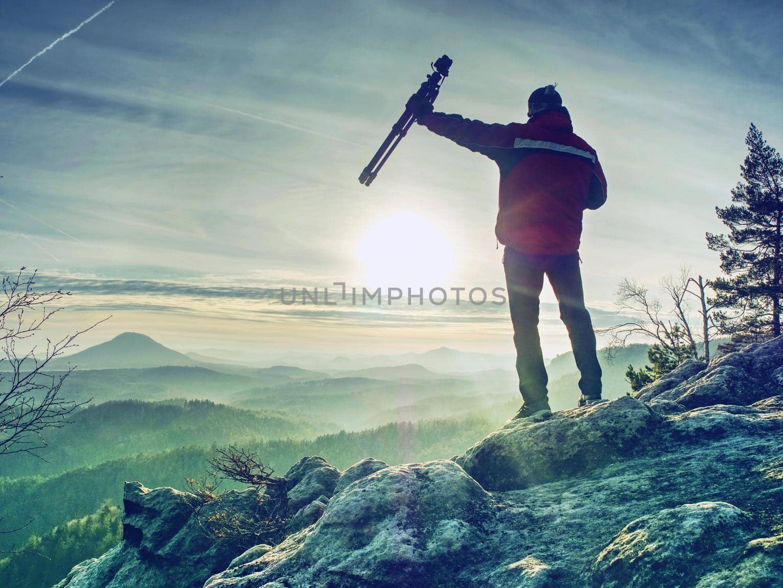 Man taking picture of landscape when sunrise at mountain peak. by rdonar2